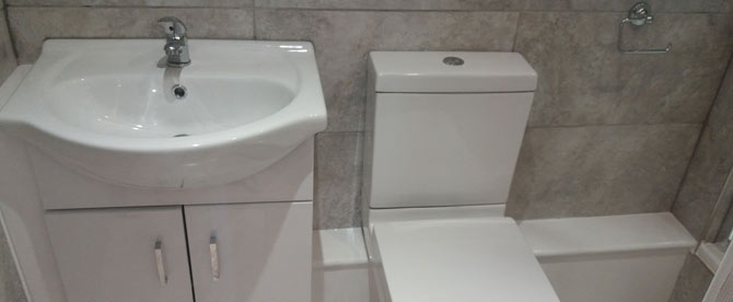 A simple double ensuite toilet and basin pictured